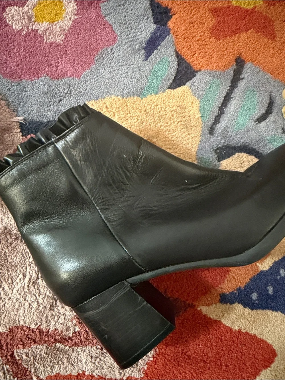 Black Leather Sole Bliss Ankle Booties with Ruffle